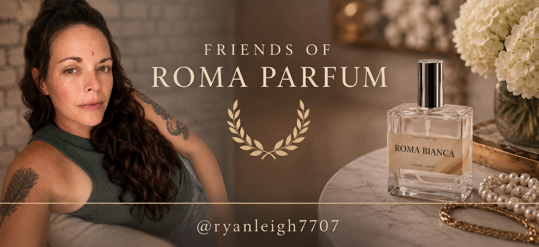 Woman with tattoos sitting next to a bottle of Roma Parfum on a table.