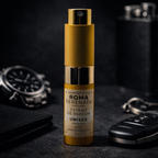 Perfume bottle labeled 'Roma Serenade' with a watch, car key, and wallet in the background on a dark surface.